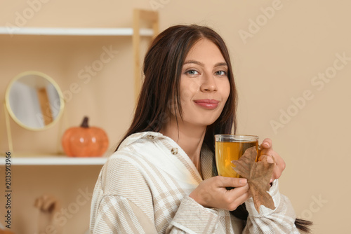 Young woman with cup of gre...
