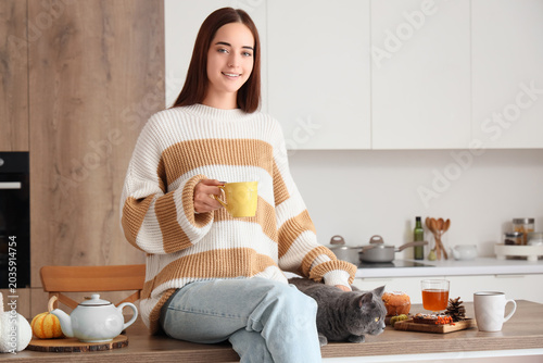 Young woman with cup of tea...