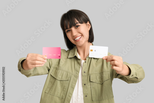 Happy young woman with cred...