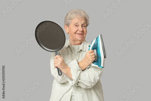 Happy senior woman with iro...