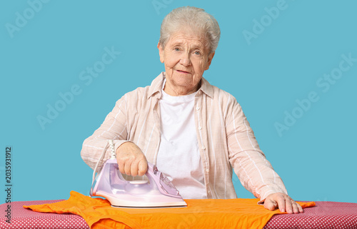 Senior woman with ironing t...