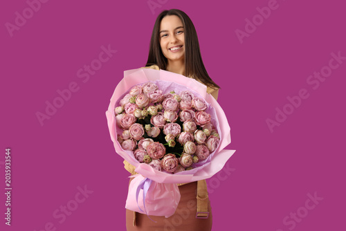 Young woman with bouquet of...