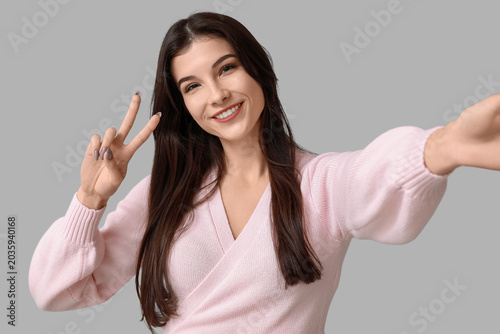 Young woman showing peace s...