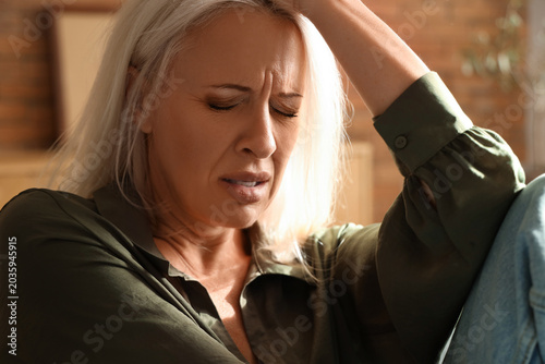 Depressed mature woman at h...