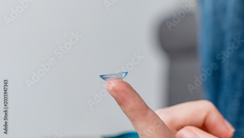 Tableau sur toile Close-up of a contact lens resting on the fingertip of a person, showcasing its