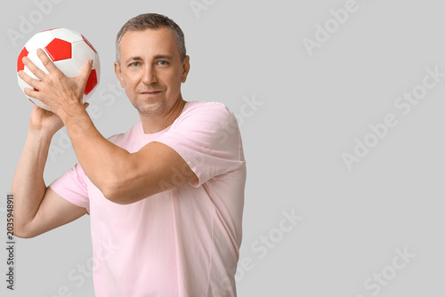 Handsome mature man playing...