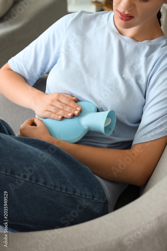 Young woman with hot water ...
