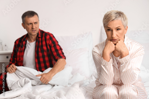 Upset mature woman with her...