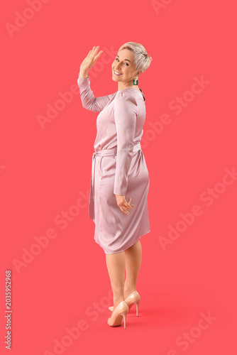 Stylish mature woman waving...