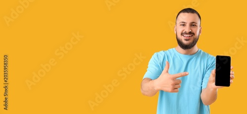 Young man pointing at mobil...