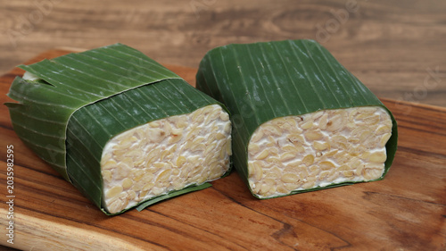 Photos Raw Tempeh or Tempe on wooden background