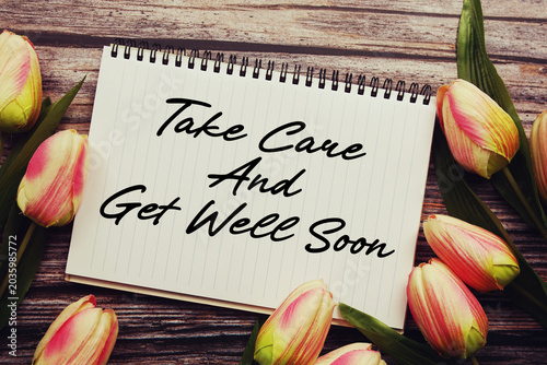 Cuadro en lienzo Take Care And Get Well Soon text written on notepad with flower decoration on wo