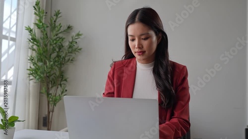 Professional asian businesswoman opening and working on laptop computer at office