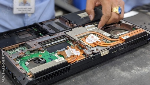 Bild auf Leinwand Repair workshop in Vietnam: PC repair: Hands of a technician disassembling a lap