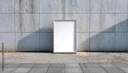 Minimalist blank picture frame outdoors on cement wall with arc pavement