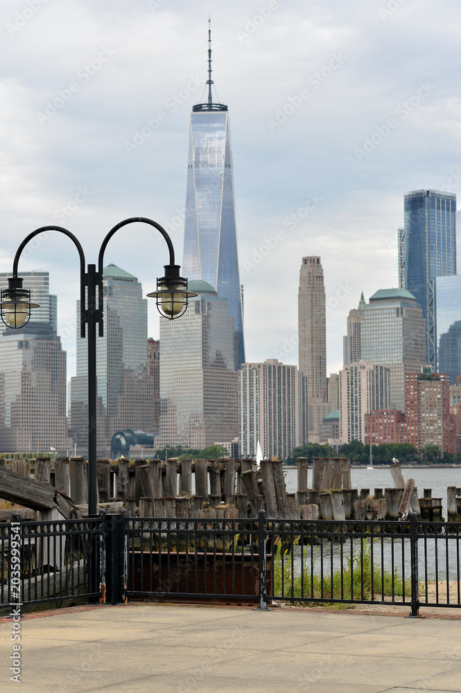 Obraz premium Traditional Lamps And Intricate Ironwork Contrast With Modern Glass Skyscrapers new york