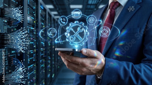 It support and digital communication concept with businessman holding smartphone in data center