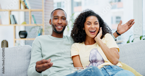 Konstfotografi Happy, relax and couple on sofa for watching tv with show, movie or series together in home