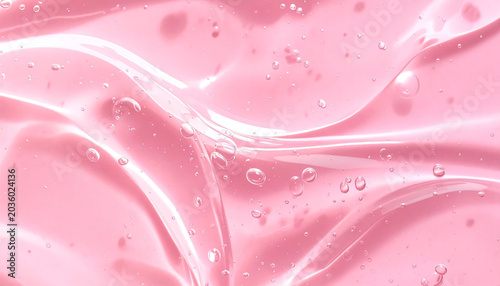 Close up of transparent pink cosmetic gel serum background