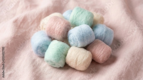 Soft Pastel Colored Cotton Candy Clustered Together on a Gentle Background