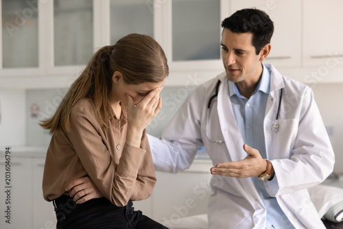 Quadro su tela Doctor offering friendly guidance and emotional reassurance to distressed woman patient in clinic during consultation