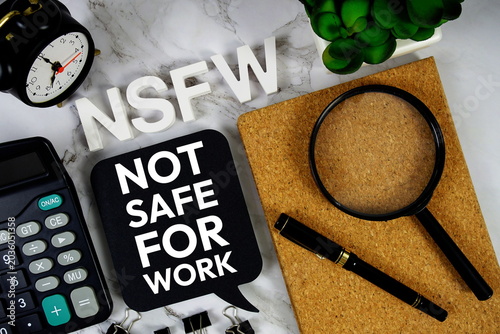 Foto NSFW - Not Safe For Work acronym with calculator, alarm clock and magnifying gla