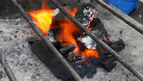 Fotografie Intense Heat Burning Charcoal Under a Grilling Grate