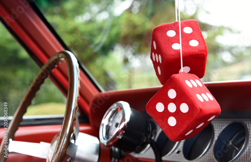 Red fluffy dice in a classic car at a car show