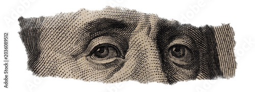 Close-up of Benjamin Franklin's Eyes on Torn Dollar Bill