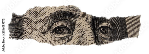 Close-up of Benjamin Franklin's Eyes on Torn Dollar Bill