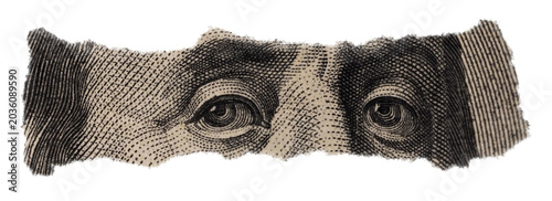 Close-up of Benjamin Franklin's Eyes on Torn Dollar Bill