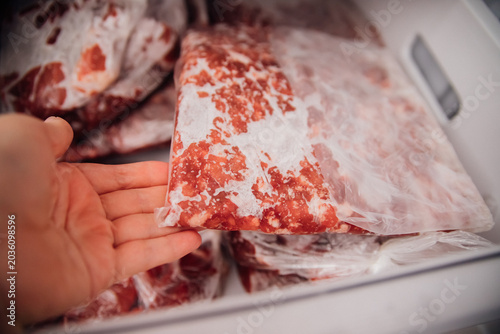 Slika na platnu Various frozen beef cuts packed in bags inside the freezer