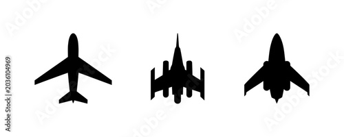 Foto Three black silhouettes of different airplanes flying in formation