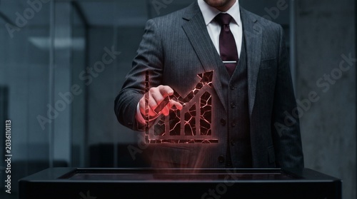 Executive pointing at cracked glowing red bar chart graph symbol.