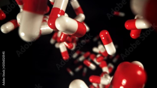 Red and white capsules tumble through black, urgent analgesic imagery Filmed on a high-speed camera at 1000 fps.