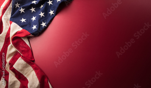 Happy Independence day concept made from American flag on dark red background.