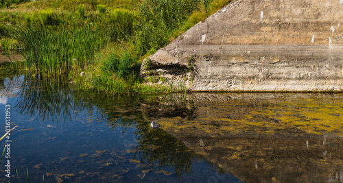 fragments of the concrete wall of the fortress of Brest above the moat