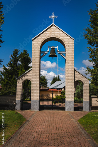 bell hanging above the entrance to a Catholic church