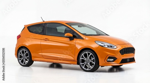 Obraz na płótnie Orange hatchback car parked on a studio floor