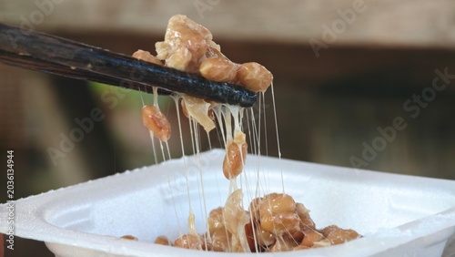 Bilde på lerret Japanese Natto lifted by chopstick.