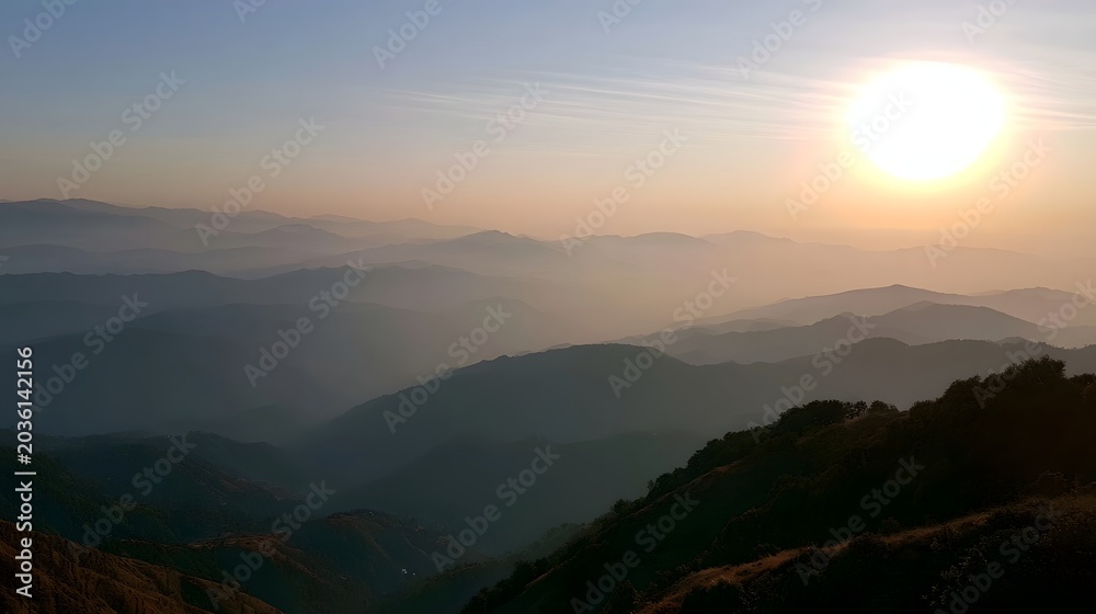 Obraz premium Misty mountain range bathed in warm golden light during the tranquil morning hours