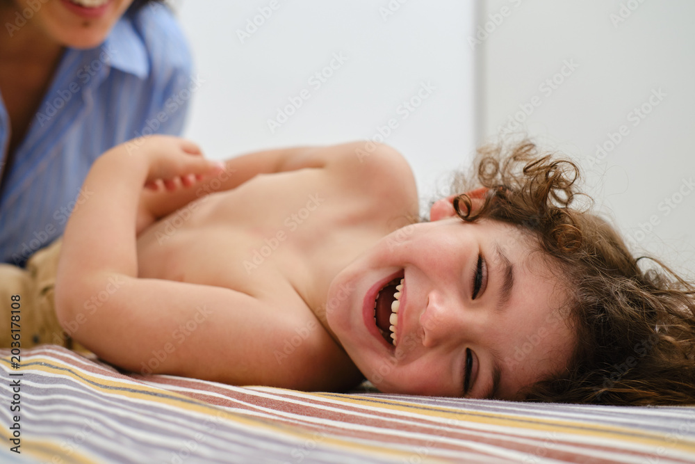 Obraz premium Happy child laughing while playing with parent at home