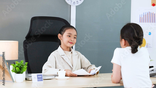 Billede på lærred Young Asian Girl in White Blazer Roleplaying as a Business Executive