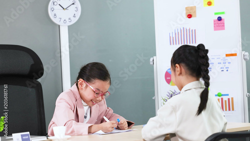 Obraz na płótnie Young Asian Girl in Pink Blazer Roleplaying Business Meeting in Office