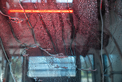 View from inside a car of a wet windshield in an automatic car wash.