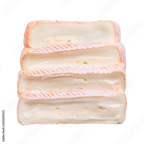 Slices of French soft cheese with washed rind. Cheese made from cow milk, featuring a washed, edible orange-red rind, and a creamy, slightly runny texture. Close-up, from above, isolated food photo