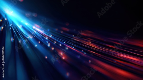 Abstract background with bright blue light rays and soft bokeh on dark background.