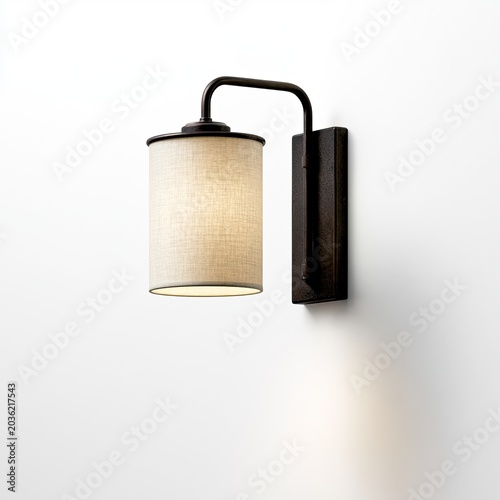 A modern, cylindrical fabric wall sconce with dark metal accents