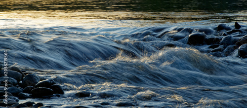 Tableau sur toile cool blue backlit water spraying in slow motion from a waterfall.