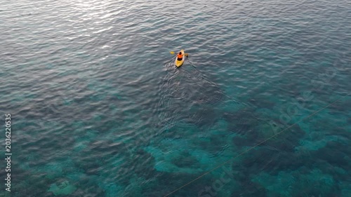 Aerial view of woman traveller exploring calm tropical bay ,Travel and Active Lifestyle concept